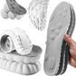 Gray and white textured insoles shown in multiple views, including a close-up of the underside, a rolled section, and a hand holding a pair. The product appears to be a pair of contoured support or massage insoles with cushioned raised sections and a textured lower surface.