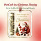 A Christmas-themed cash-blessing gift tag or ornament design shown on a soft pink background. The product features a rolled dollar bill inside a clear cylindrical section, gold decorative script text reading 'Christmas,' Santa Claus illustration, a small Christmas tree, and wrapped gifts.