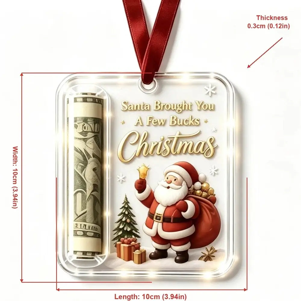 A square Christmas ornament with a red hanging ribbon, featuring a printed Santa Claus design, gold 'Christmas' lettering, a rolled dollar bill insert, and warm light effects inside a clear case. Red measurement lines and text show the dimensions: 10 cm by 10 cm, with thickness 0.