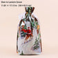 A festive drawstring gift bag with a printed winter scene featuring Santa Claus on a deer, evergreen trees, and snowy ground. The bag is shown against a solid pale peach background with text at the top reading 'Deer in Lantern Grove