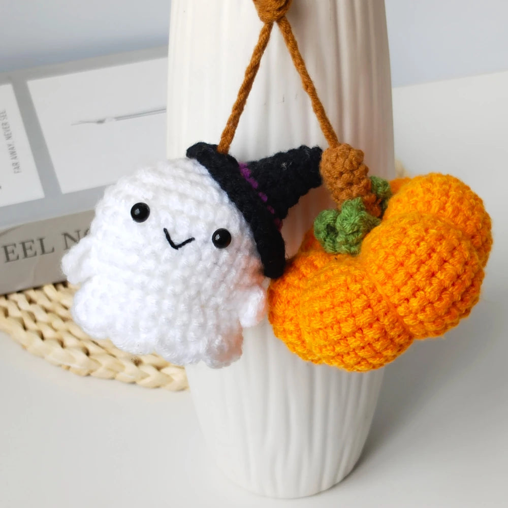 Crochet ghost and pumpkin charm used as a hanging bag accessory