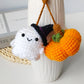 Crochet ghost and pumpkin charm used as a hanging bag accessory