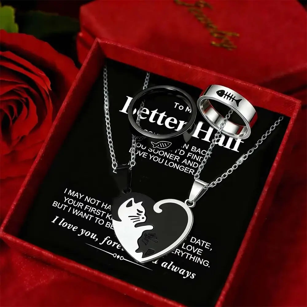 A three-piece metal heart pendant necklace set for couples, displayed inside a red gift box with red roses. The set includes a round pendant engraved with 'I Letter H' and 'To M', a heart-shaped pendant with a cat silhouette and 'I always' text, and a silver ring with a fish skeleton motif.