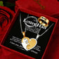 A jewelry gift set displayed inside a red presentation box with a red rose. The set includes a silver and gold heart pendant necklace with a cat design, a silver ring, and a gold fishbone ring, all on a black message card with romantic text.