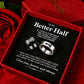 A gift box containing two rings, one black and one silver, with a romantic message printed on the insert card. Red roses and a red fabric background surround the box.