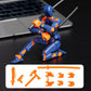 A blue and orange plastic robot action figure posed kneeling on a dark tabletop with a laptop blurred in the background. A white label at the bottom shows additional orange accessory pieces.