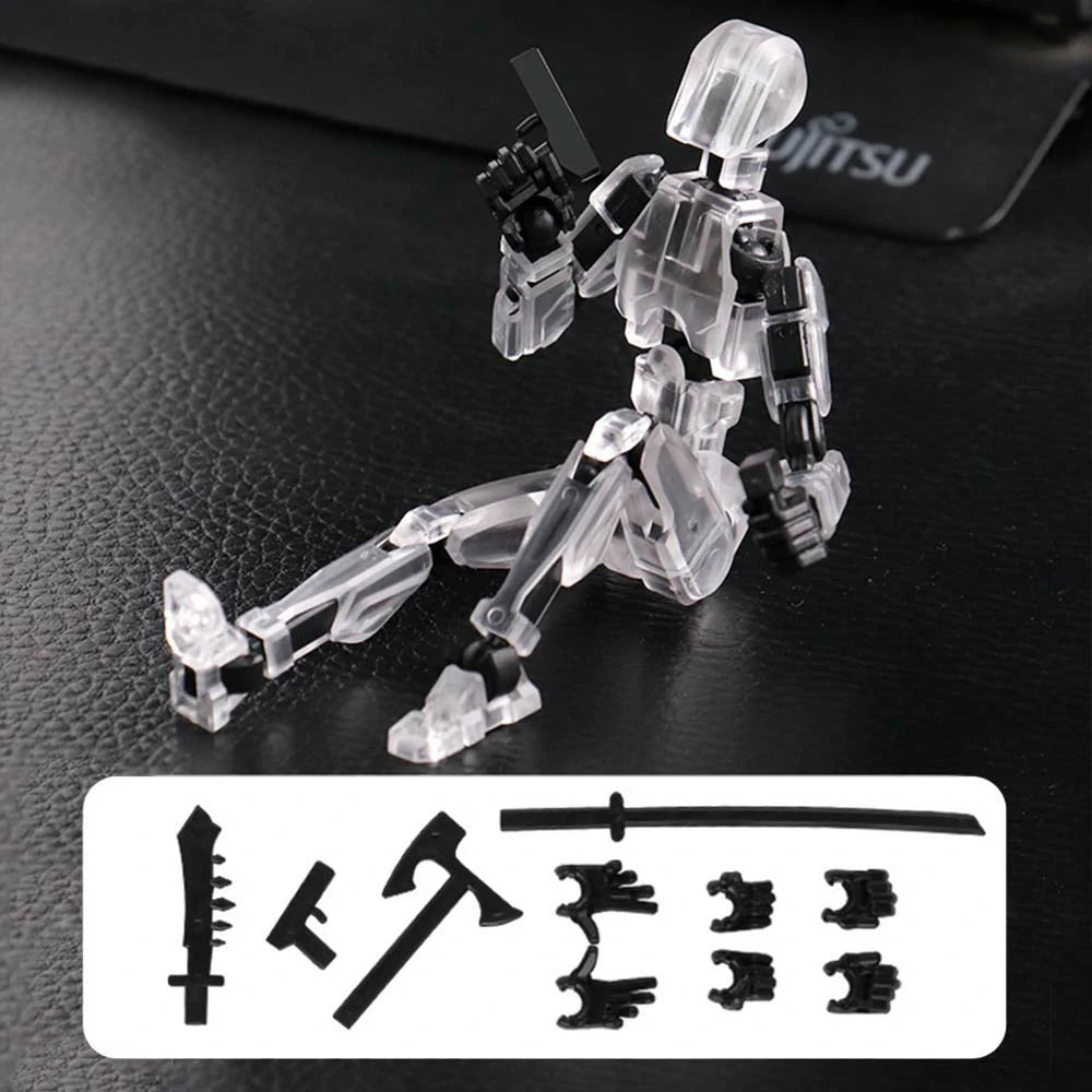 A transparent acrylic action figure of a kneeling robot or mecha on a black textured surface, with interchangeable black weapon and limb accessories shown in a white box at the bottom.