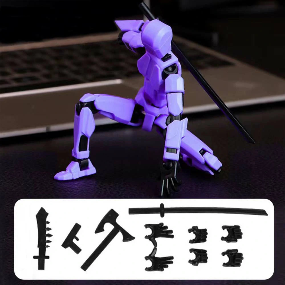 A purple and black articulated mecha action figure posed with a sword on a dark surface, with a laptop blurred in the background and a white panel showing included accessories at the bottom.