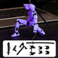 A purple and black articulated mecha action figure posed with a sword on a dark surface, with a laptop blurred in the background and a white panel showing included accessories at the bottom.