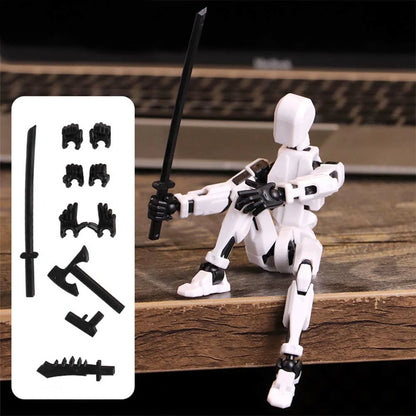 A small white articulated action figure posed sitting on a wooden surface and holding a black sword. The image includes a white inset panel on the left showing additional black accessory pieces such as hands, grips, an axe, and a sword blade.