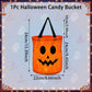 An orange Halloween candy bucket with a jack-o'-lantern face and black handles, shown with printed dimension arrows and labels on a pale blue decorative background.