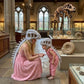 A woman and a child wearing dinosaur skull and back armor costumes pose in a dinosaur museum, with a T-rex skeleton and fossils visible in the background.
