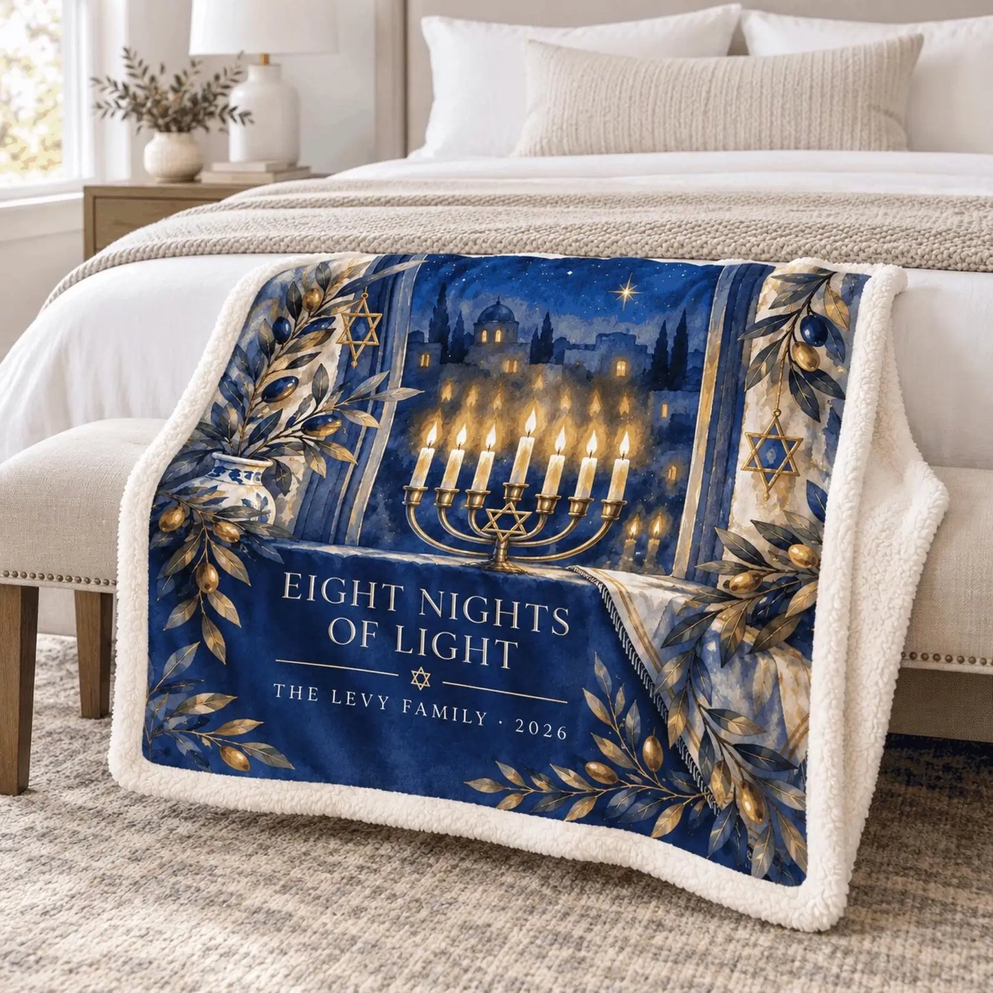 The menorah blanket with a personalized Eight Nights of Light text lies on a bench in a cozy bedroom