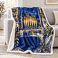 The blue and white plush menorah blanket is draped over a grey sofa in a bright living room