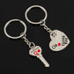Two silver key-shaped keychains with 'I LOVE YOU' text on a black background