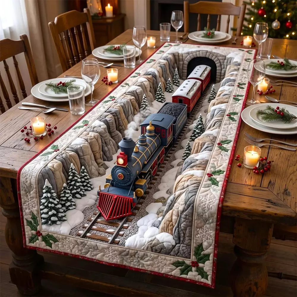 A quilted table runner with snowy mountain tunnel track 3D effect and a vintage steam train model on a wooden table with plates candles and a lit Christmas tree