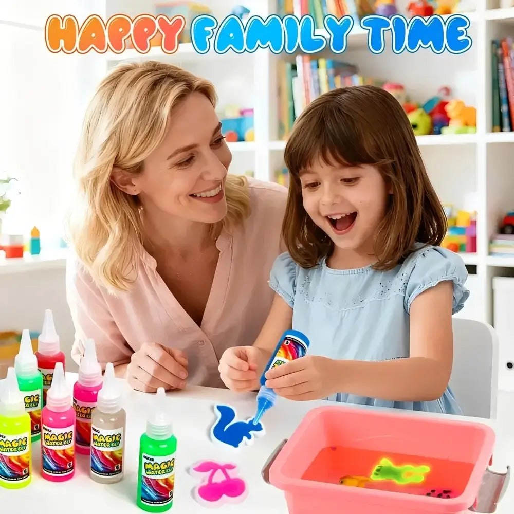 A woman and a young girl are sitting at a table with colorful craft bottles, a pink tub of liquid, and clay shapes, with the text 'HAPPY FAMILY TIME' at the top. The scene is brightly lit and set in a playroom environment.