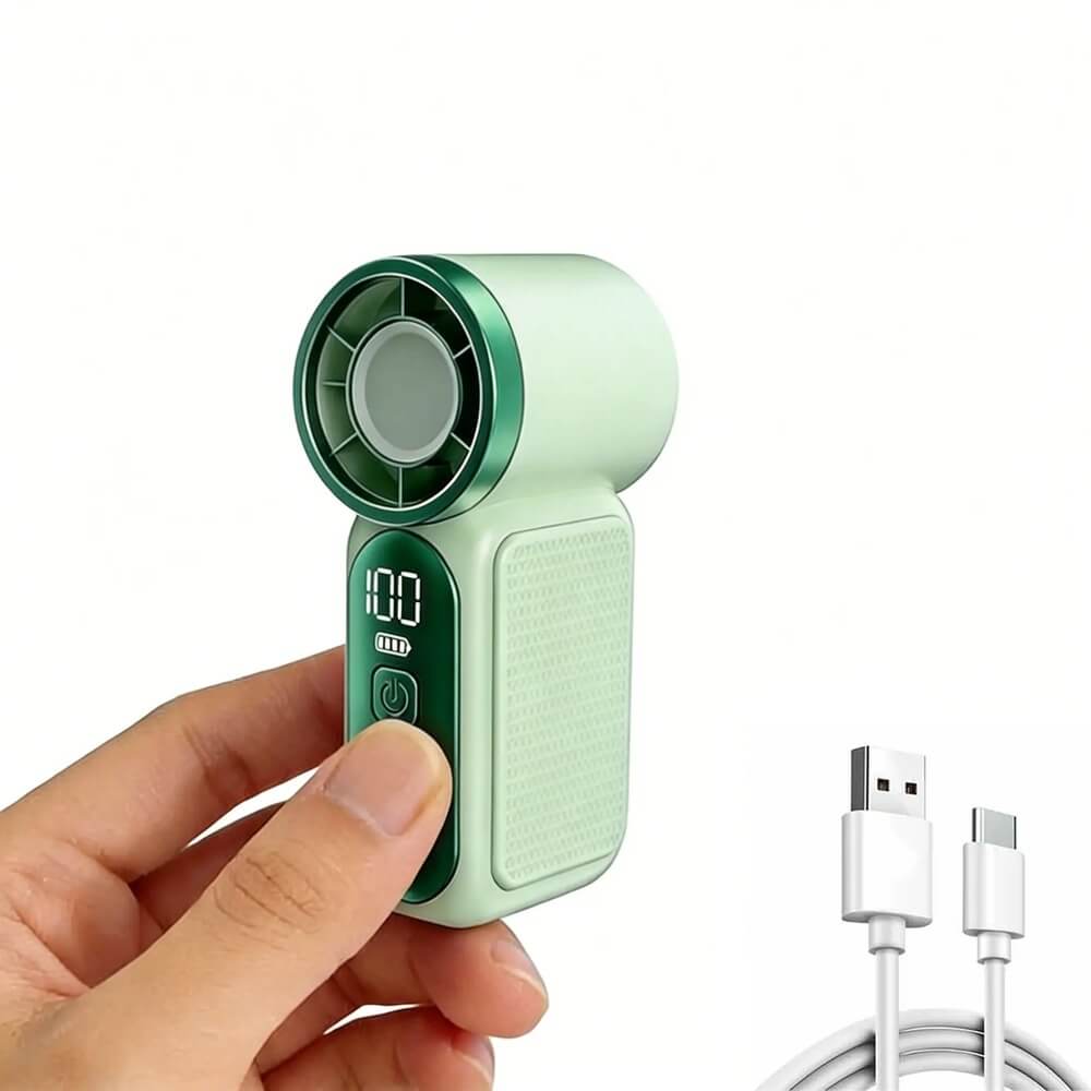 A handheld mini fan in mint green and dark green, held by a person's hand against a white background, with a white USB charging cable shown in the lower right corner.