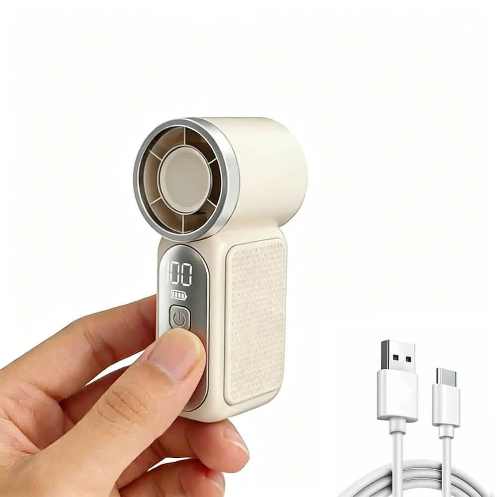 A hand-held portable mini fan in cream and silver, shown being held by a hand with a white USB-C charging cable on a plain white background.