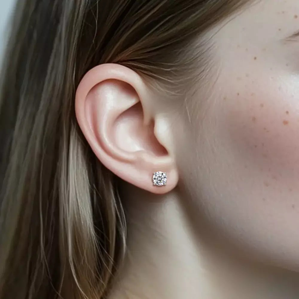 Solitaire moissanite stud earring shown on the ear