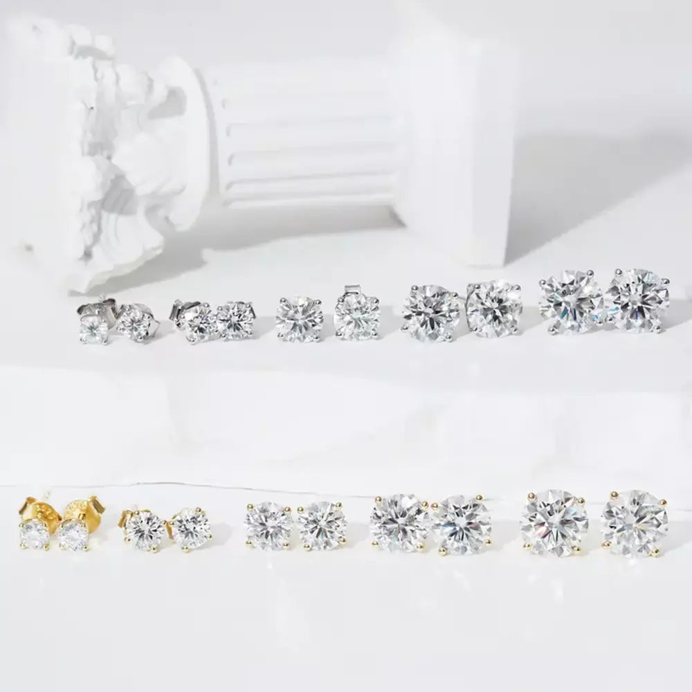 Pair of solitaire moissanite stud earrings displayed with jewelry