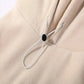 Close-up of a black button on a beige fabric background