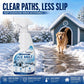 A snowy outdoor scene with a golden retriever stepping out of a blue doghouse beside a deicer spray bottle on a snowy stone path