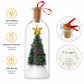 A clear glass bottle Christmas ornament with a cork stopper, red ribbon, and a miniature decorated Christmas tree inside. The image includes feature callouts: 'Recordable' with voice personalization, 'Battery Powered' for anywhere use, and 'Gift-Ready' for holidays, plus two circular inset close-ups showing the cork/ribbon top and the back speaker panel.