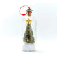 Decorative Christmas tree in a glass bottle with a gold star on a white background